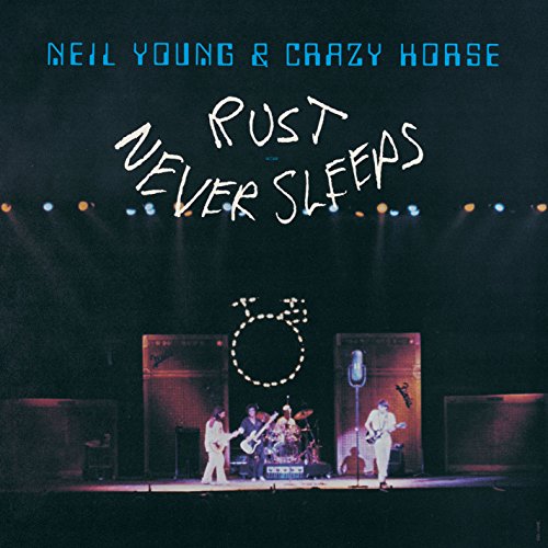 "Album cover of Neil Young & Crazy Horse's 'Rust Never Sleeps' featuring a live stage performance."