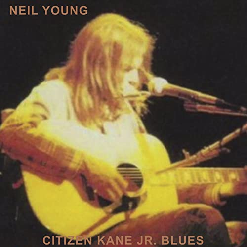 Neil Young playing acoustic guitar, album cover for "Citizen Kane Jr. Blues.