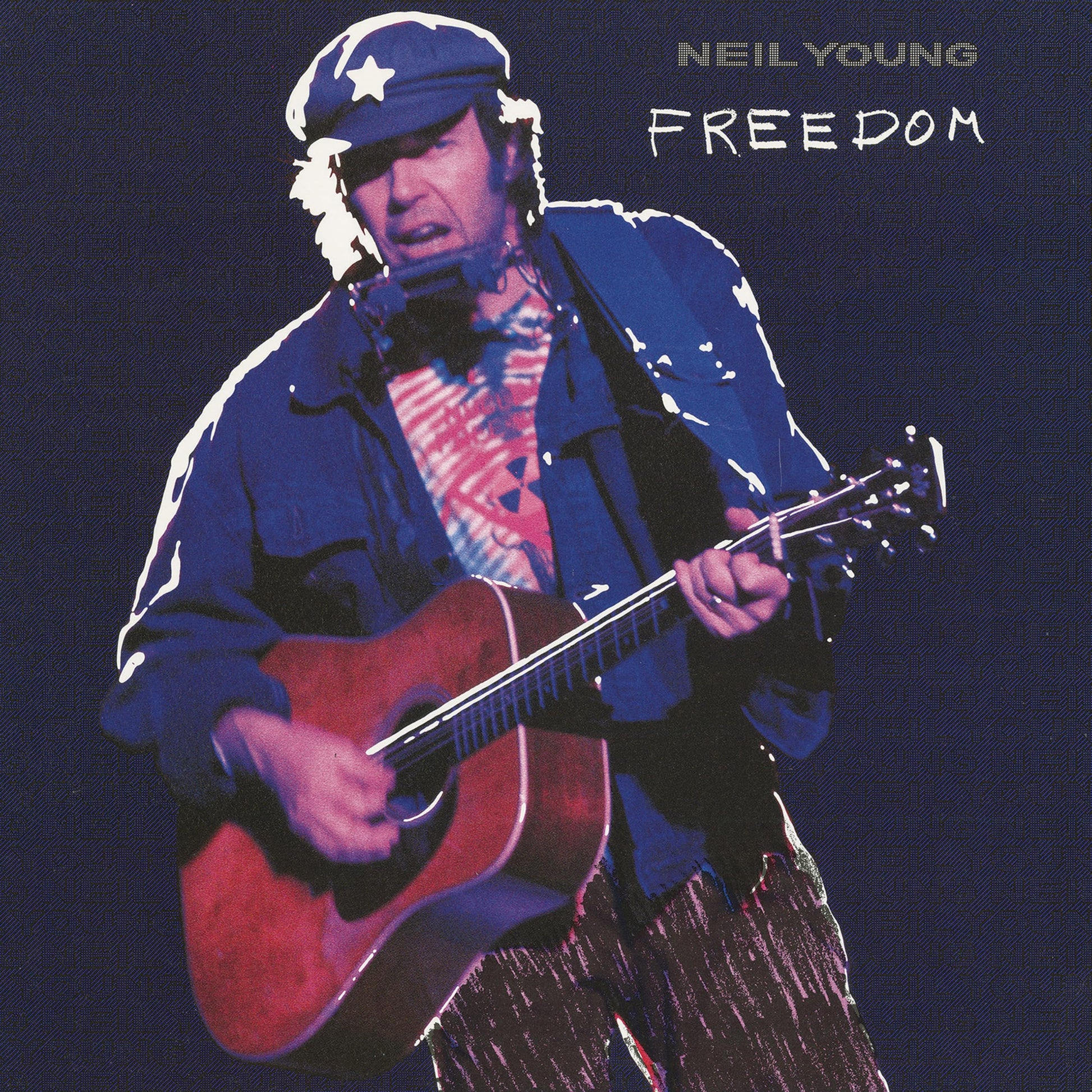 Neil Young playing acoustic guitar, wearing a cap with a star.