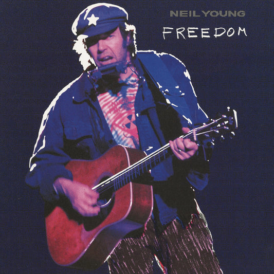Neil Young playing acoustic guitar, wearing a cap with a star.