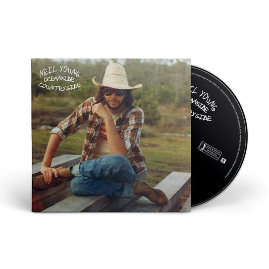 Neil Young “Oceanside Countryside” CD cover featuring a portrait in a field.