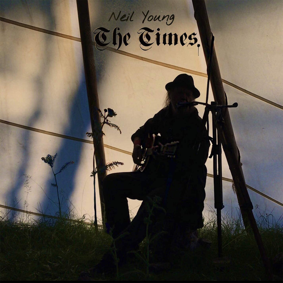 Album cover featuring Neil Young sitting with a guitar, outdoors, in a silhouette.