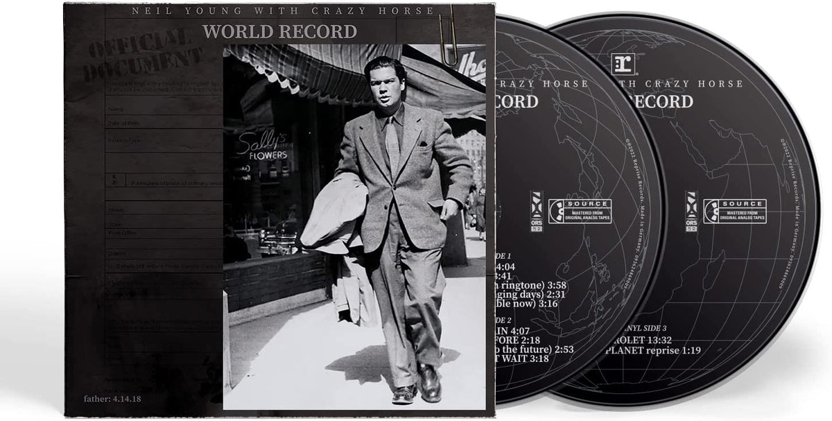 Album cover with Neil Young walking on sidewalk in a suit.