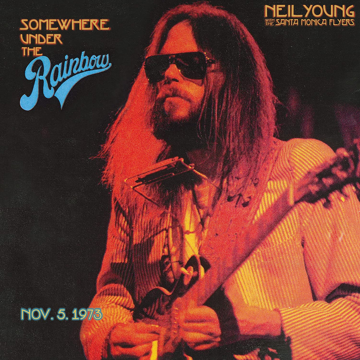 "Album cover featuring Neil Young playing guitar, with title and date."