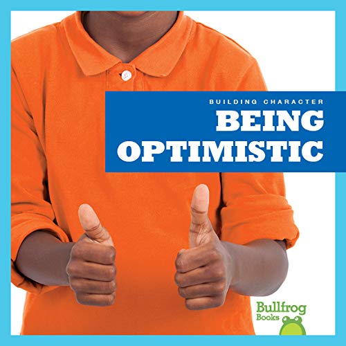 A person in an orange polo shirt giving a thumbs up with both hands.