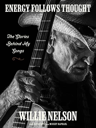Black and white portrait of Willie Nelson with his guitar.