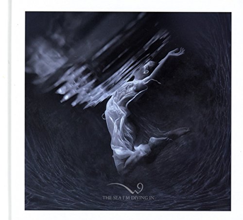 Underwater figure with flowing fabric, dark blue and white tones.