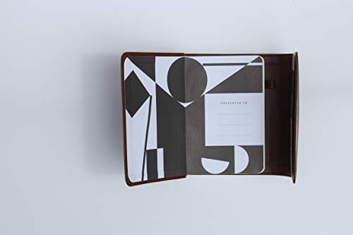 Brown leather-bound Bible open to a presentation page with abstract design.