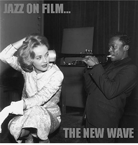 Black and white photo of a woman and a jazz musician with a trumpet.