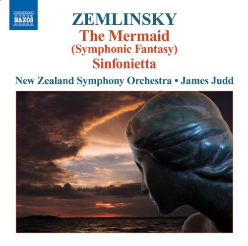 A CD cover featuring a mermaid statue against a cloudy sunset background.
