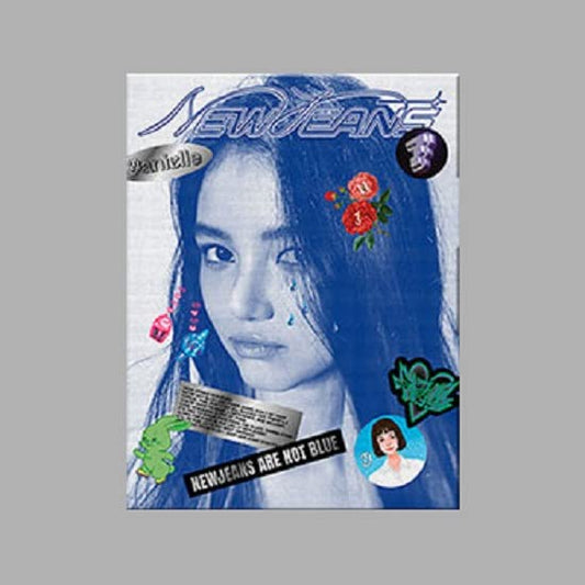 NewJeans album cover: blue-toned portrait with stickers and text.