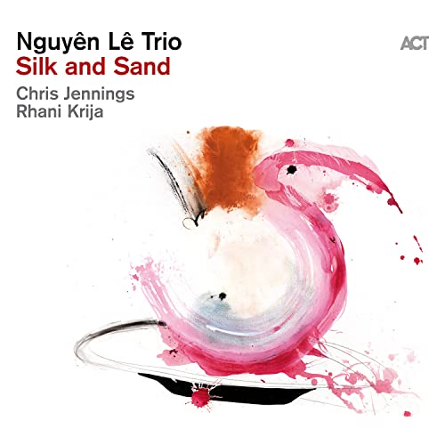 Album cover for Nguyen Le Trio’s “Silk And Sand” featuring abstract pink and orange brushstrokes.