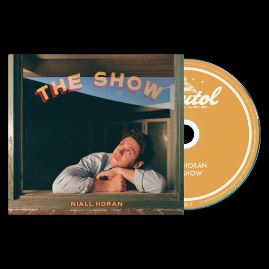 Niall Horan CD case with a man leaning on a windowsill and an orange disc.