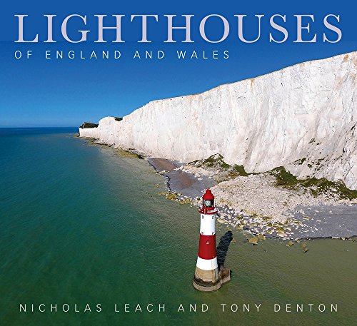 Red and white striped lighthouse at the base of white chalk cliffs.
