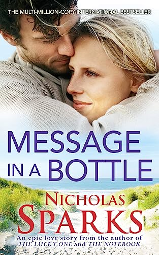 Book cover showing a couple embracing against a backdrop of sand dunes and ocean.