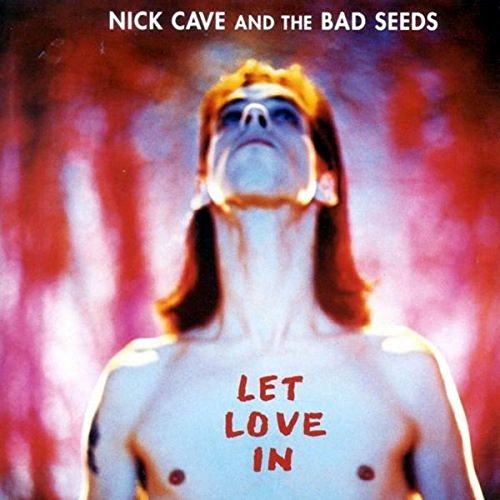 "Album cover with a man engulfed in flames and 'Let Love In' written on his chest."