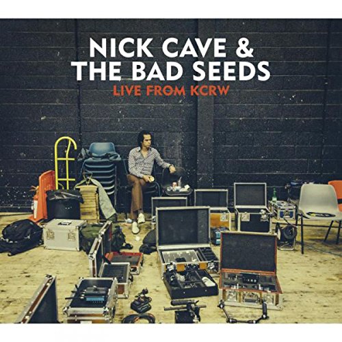 "Album cover featuring a man surrounded by musical equipment and cases."