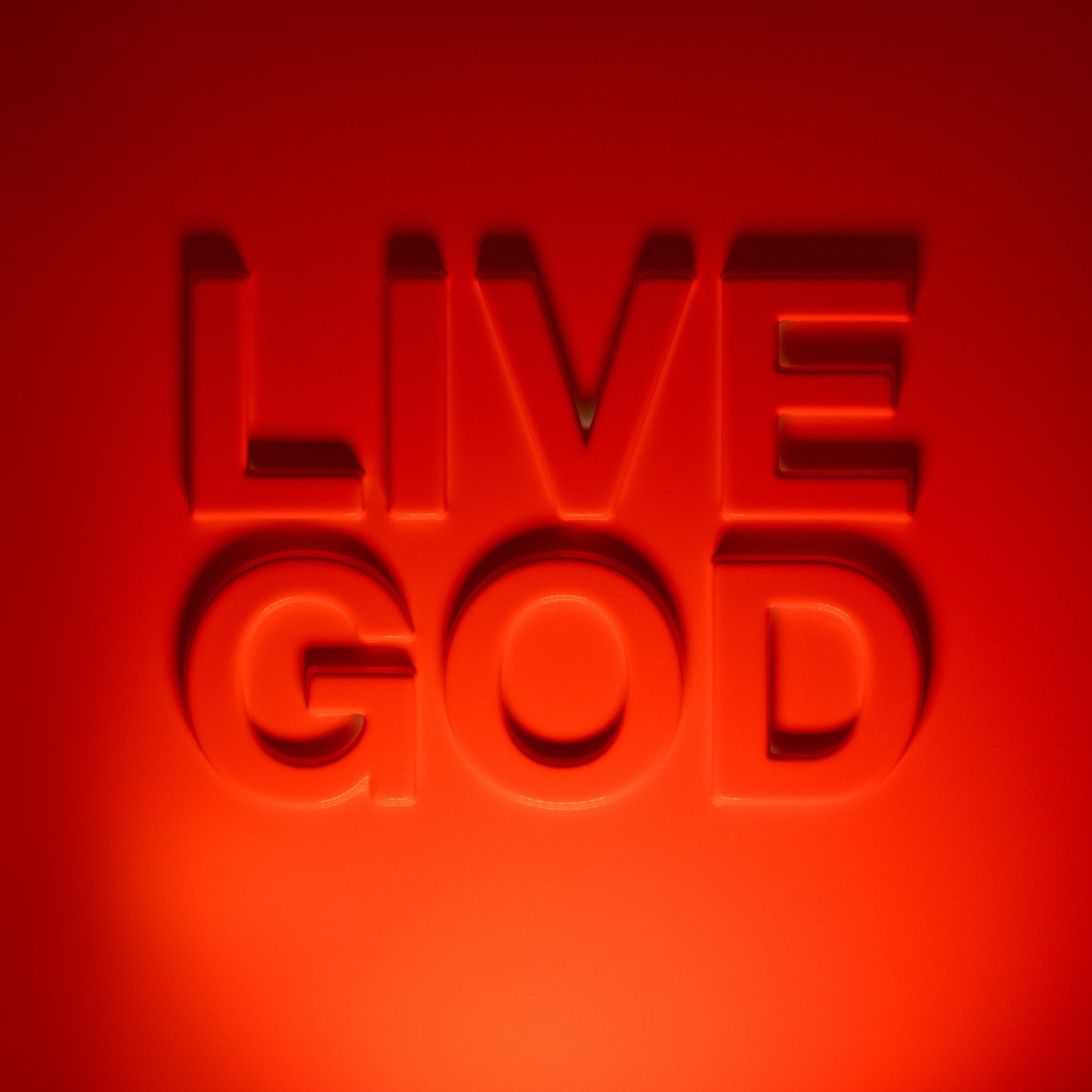 Red, embossed lettering spells “LIVE GOD” against a vibrant red background.