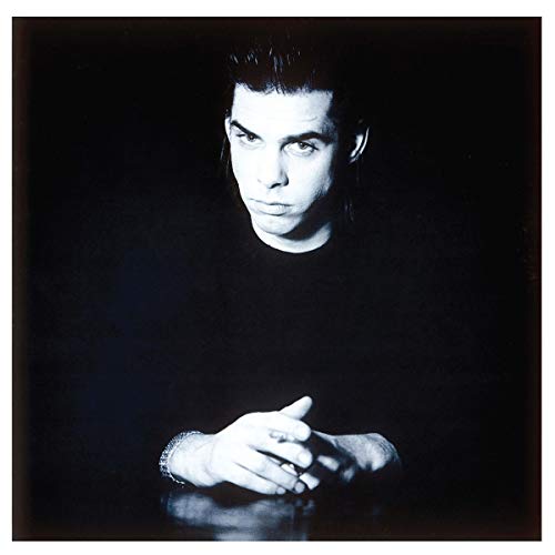 Black and white album cover featuring Nick Cave with hands clasped, against a dark background.