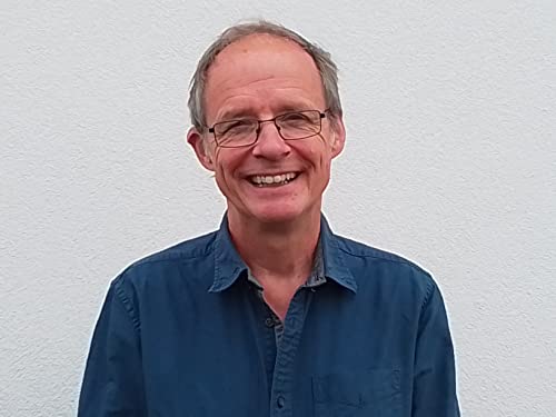 Headshot of a smiling man with short hair and glasses.