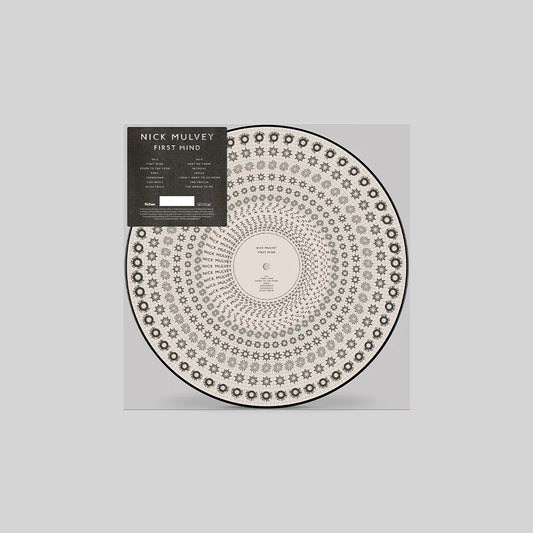 Vinyl record of Nick Mulvey’s “First Mind” with circular patterned sleeve.