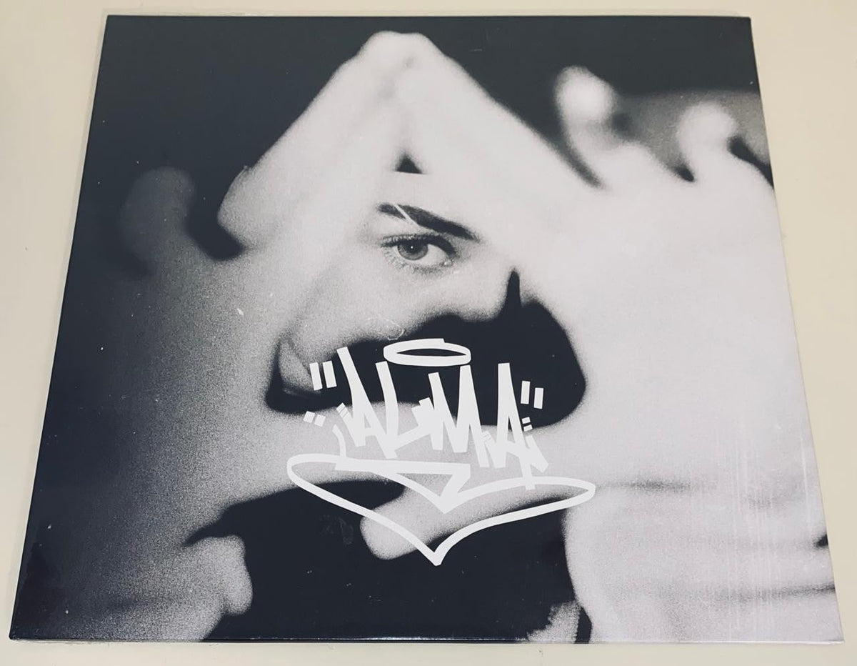 Black and white vinyl record cover with a face and graffiti text.