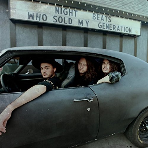 Three musicians in a dark car, album title above them.