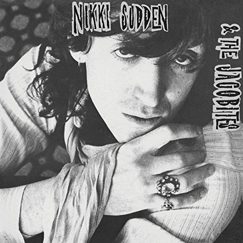 Black and white portrait of Nikki Sudden with hands clasped, album cover.