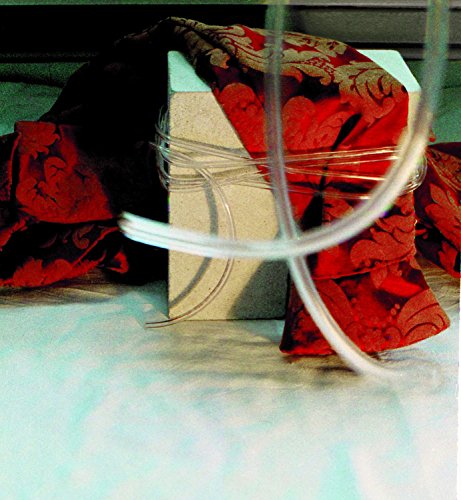 A beige block wrapped in red patterned fabric and clear plastic tubing.