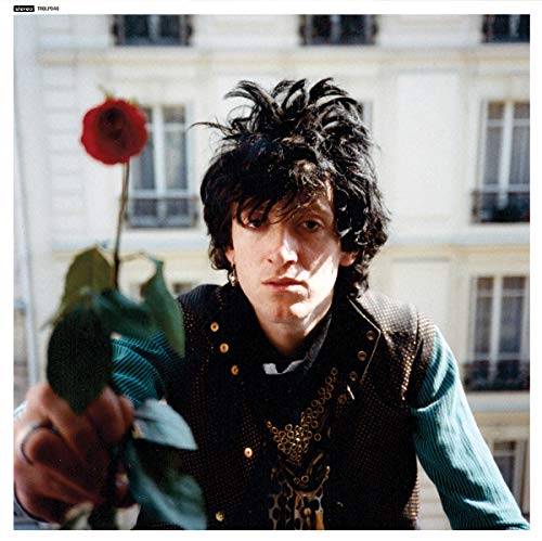 Nikki Sudden album cover: man with red rose, urban background.
