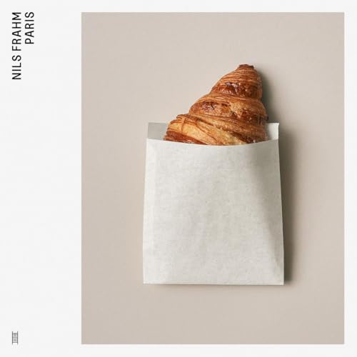 Album cover for Nils Frahm's "Paris" featuring a croissant in a bag.