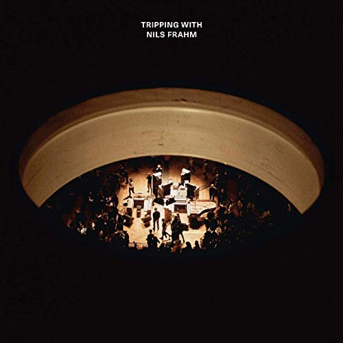 Album cover showing a concert stage viewed through a circular archway in darkness.