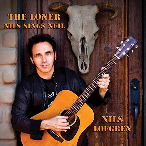 Nils Lofgren with acoustic guitar, skull, and wooden door background.