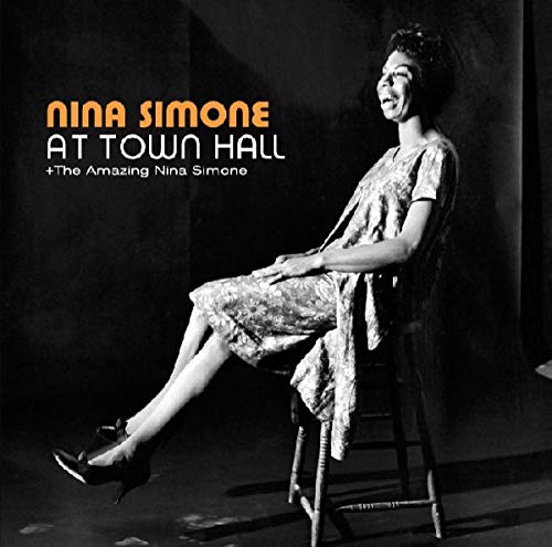 Black and white album cover of Nina Simone seated on a stool.