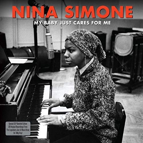 Nina Simone at a piano with a microphone, album cover art.
