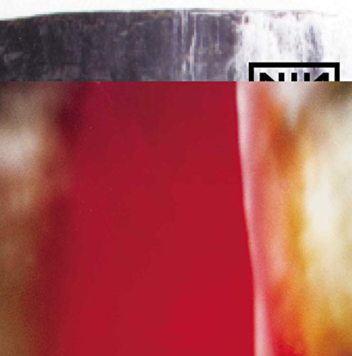 Blurry image of a test tube with red liquid and a black logo.