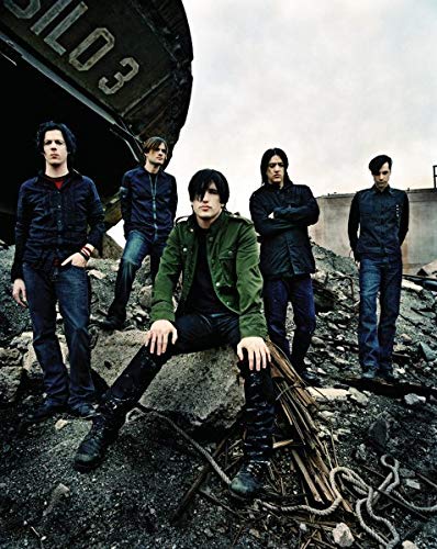 Nine Inch Nails band members standing amongst rubble and debris.