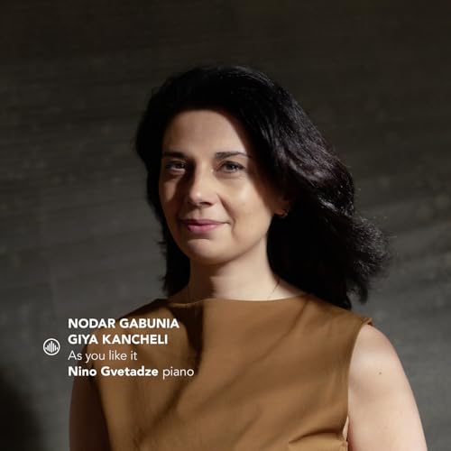Woman with dark hair and brown top against a gray background with text overlay.