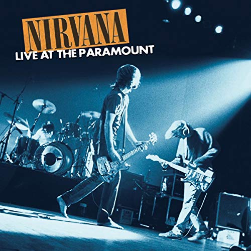 Nirvana performing live on stage, with drums and guitars visible.