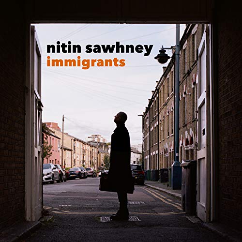 Album cover for Nitin Sawhney’s “Immigrants” featuring a man in a doorway.