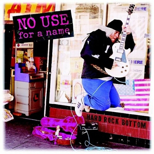 Album cover: musician playing guitar in front of a storefront.