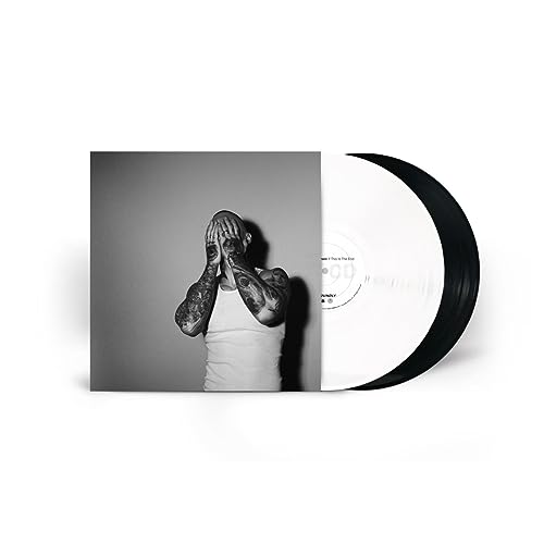 Black and white vinyl record next to its cover featuring a tattooed man.