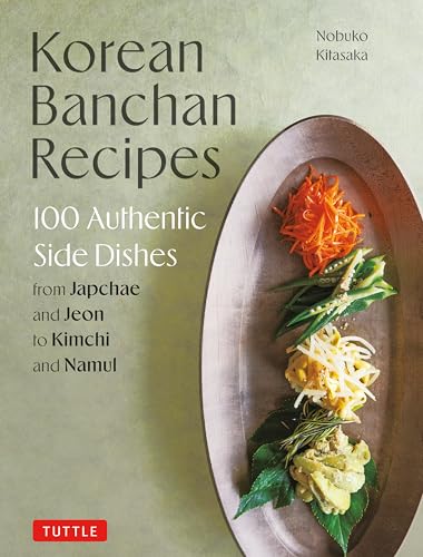 Cookbook cover featuring Korean side dishes on a rustic plate.