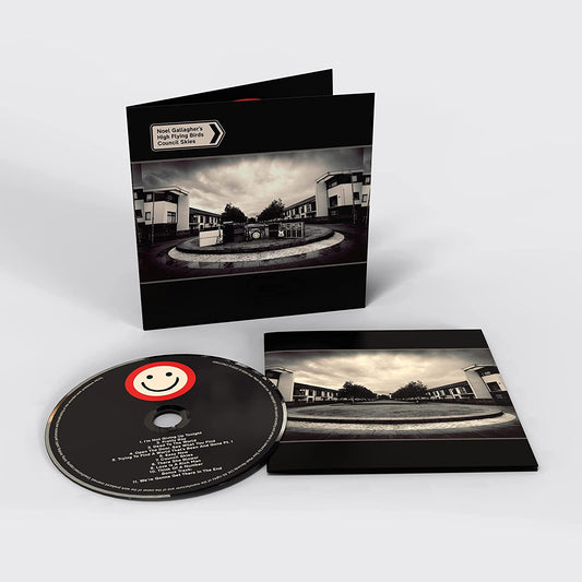 "CD case with black cover and black CD featuring smiley face logo."