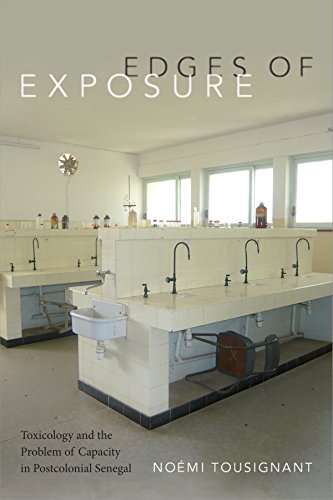 BookHollow white tiled laboratory benches with black faucets in a bright, sparse room.