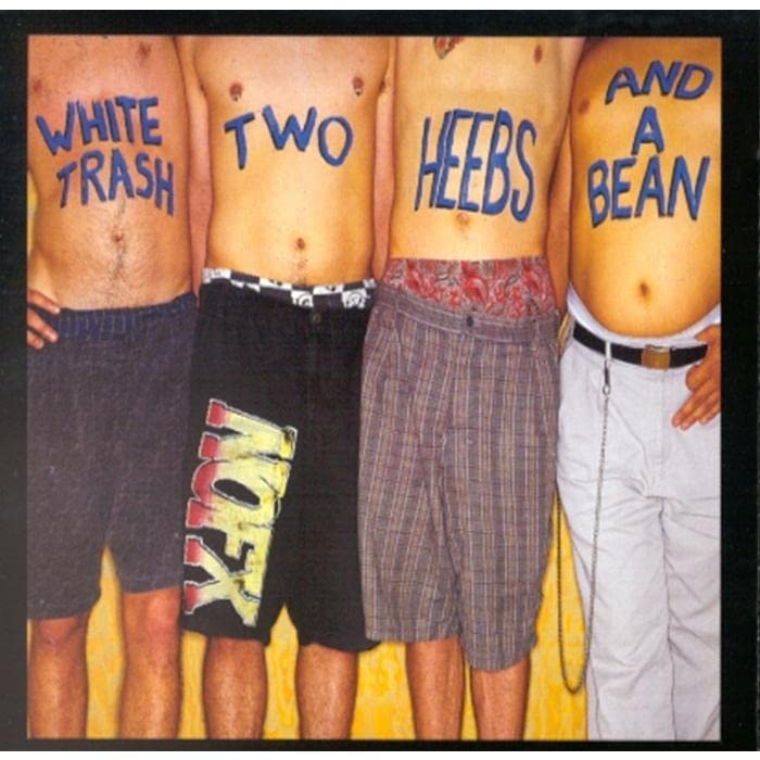Four shirtless men with blue text written on their torsos wearing various shorts.