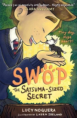 A boy in a school uniform holds a tiny dog in his cupped hands.