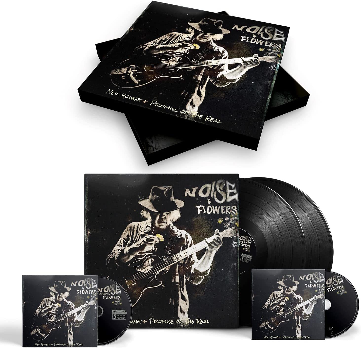 "Bluray, vinyl, and CD cases with black cover featuring white image of man playing guitar."