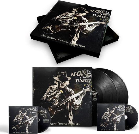 "Bluray, vinyl, and CD cases with black cover featuring white image of man playing guitar."