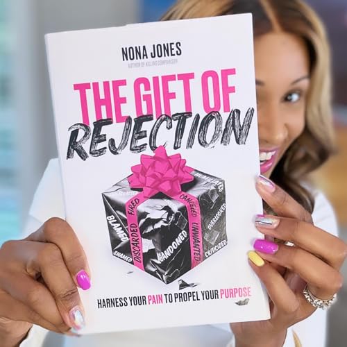 A woman holding a book titled The Gift of Rejection with a gift box.